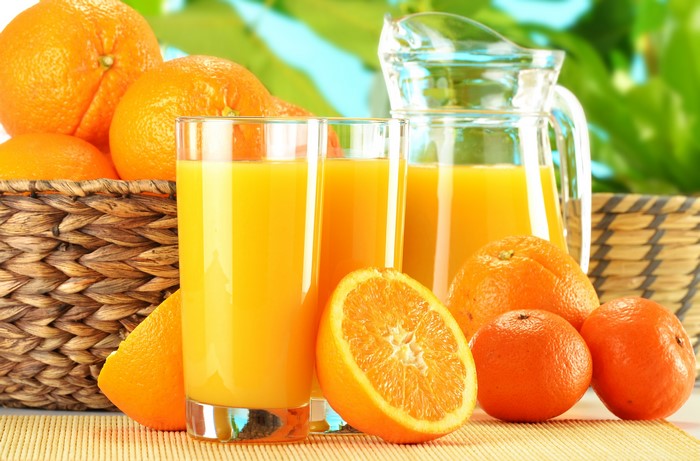 4K Orange Fruit Juice in Glasses and Jug