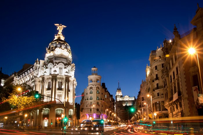 Street view of Madrid at night with light trails