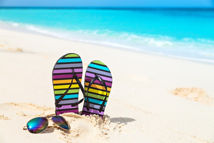 Colorful Flip-flops and Sunglasses on a Sandy Beach