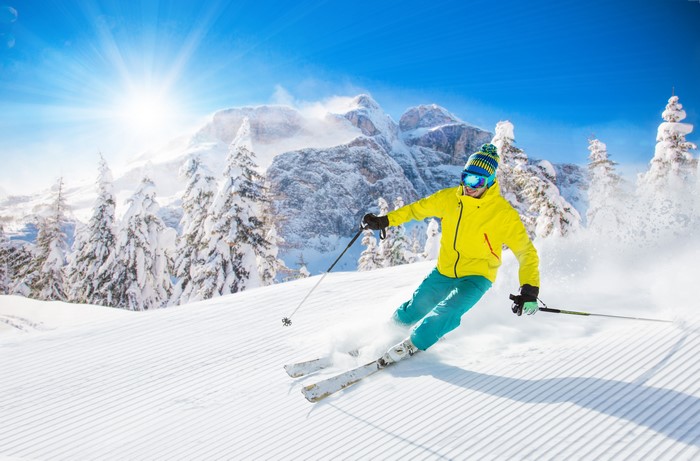 Man skiing down a snowy mountain slope