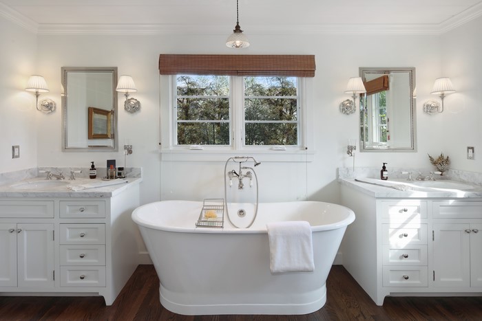Bathroom with freestanding tub and dual vanities