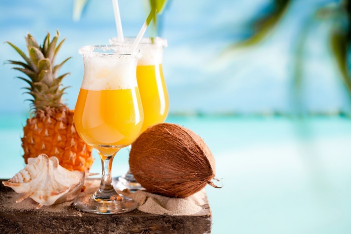 Tropical Cocktails with Pineapple and Coconut on Beach