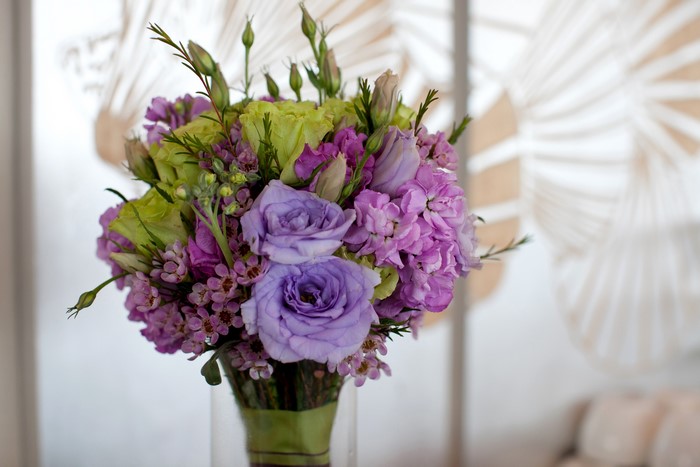 Purple and green floral bouquet in a vase