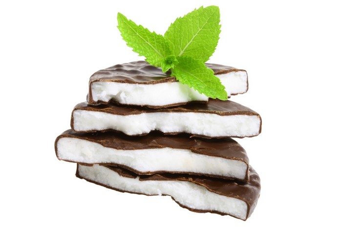 Stack of chocolate mint candies with mint leaves