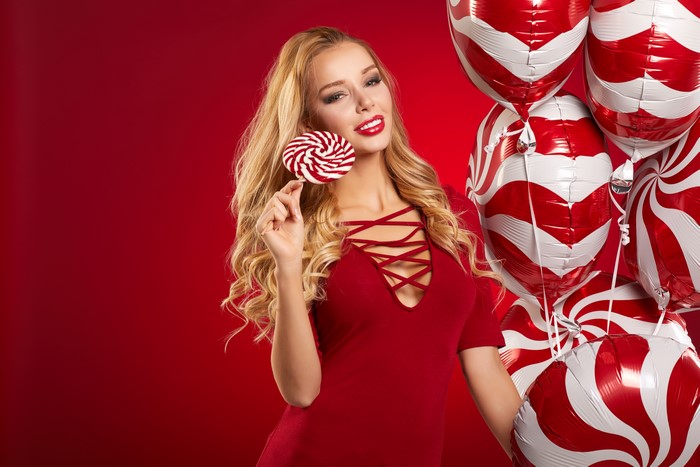 Blonde girl with lollipop and balloons