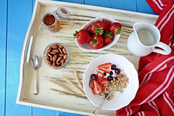 Breakfast Tray with Muesli, Strawberries, Nuts, and Milk