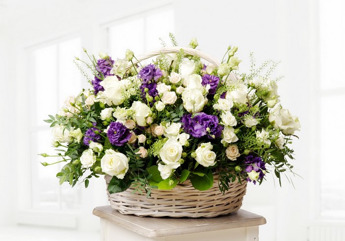 White and purple flowers in a wicker basket