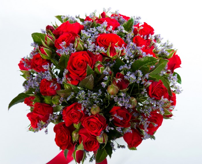 Bouquet of red roses with purple filler flowers