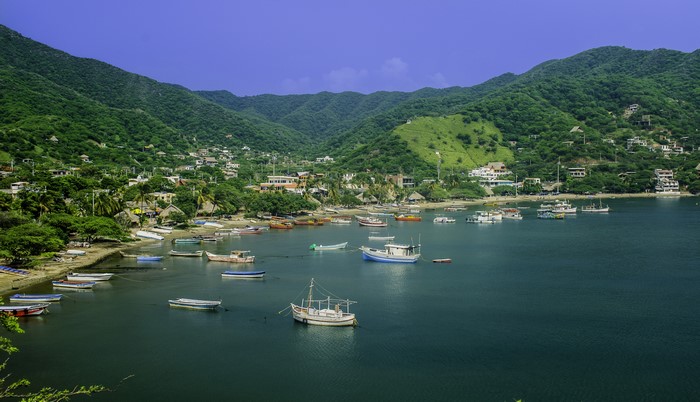 Boats in a bay with mountains and houses in Colombia