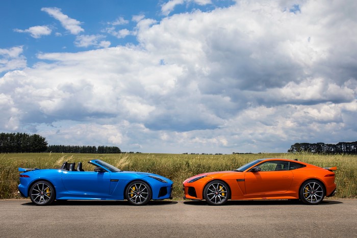 Two Jaguar F-Type cars, blue convertible and orange coupe
