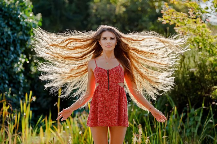 Woman with long flowing hair in a red dress