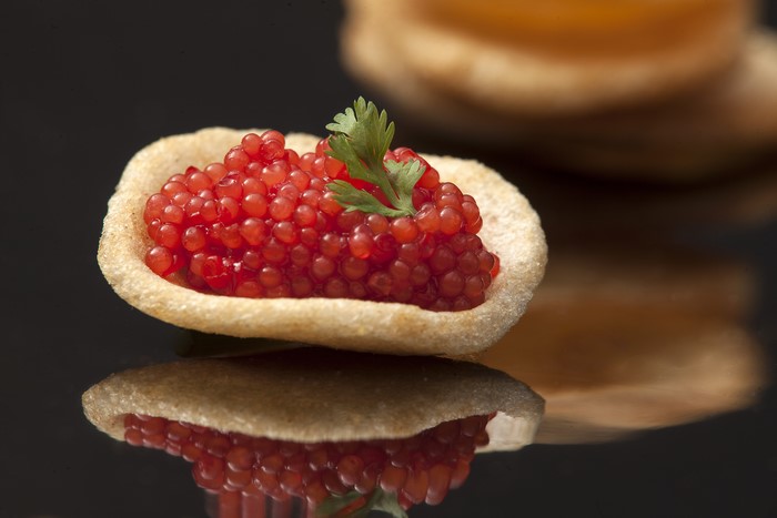 Caviar in a small pastry shell with parsley garnish