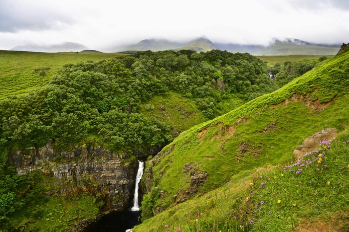 Waterfall in a green canyon in Scotland