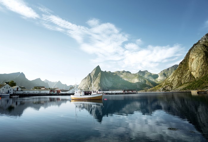 Fishing boat in a Norwegian fjord with mountains