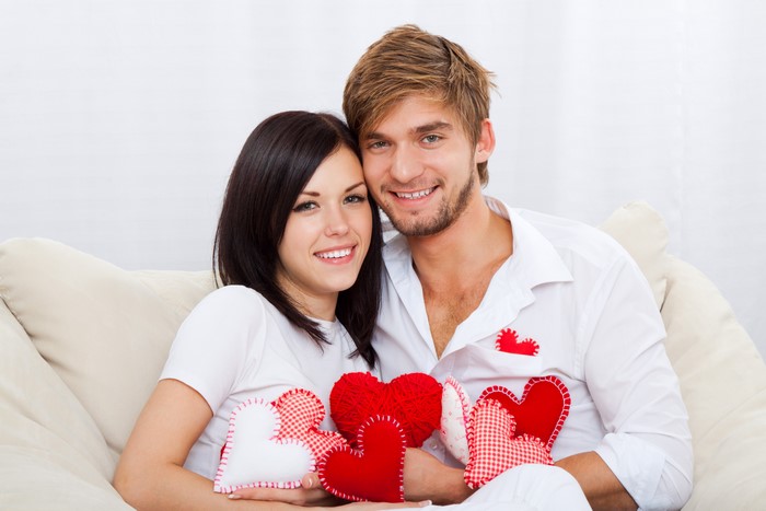 Couple holding hearts on Valentine's Day