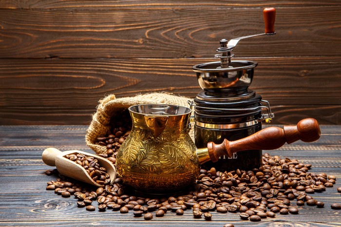 Coffee beans, cezve, and coffee grinder