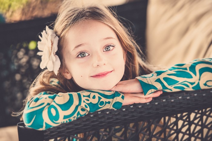 Young girl with a flower in her hair smiling