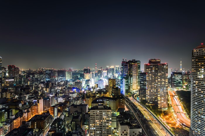 Nighttime cityscape of Tokyo, Japan with illuminated buildings and highways
