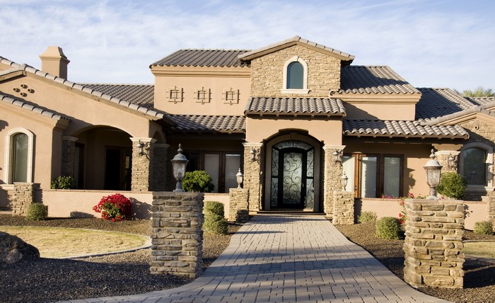 Luxury Mansion with Stone Pillars and Arched Entrance