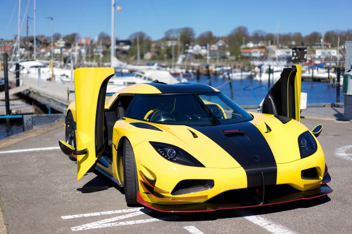 Yellow Koenigsegg One:1 supercar with doors open