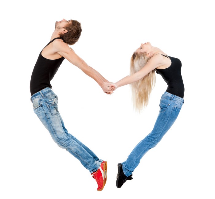 Couple forming a heart shape on white background
