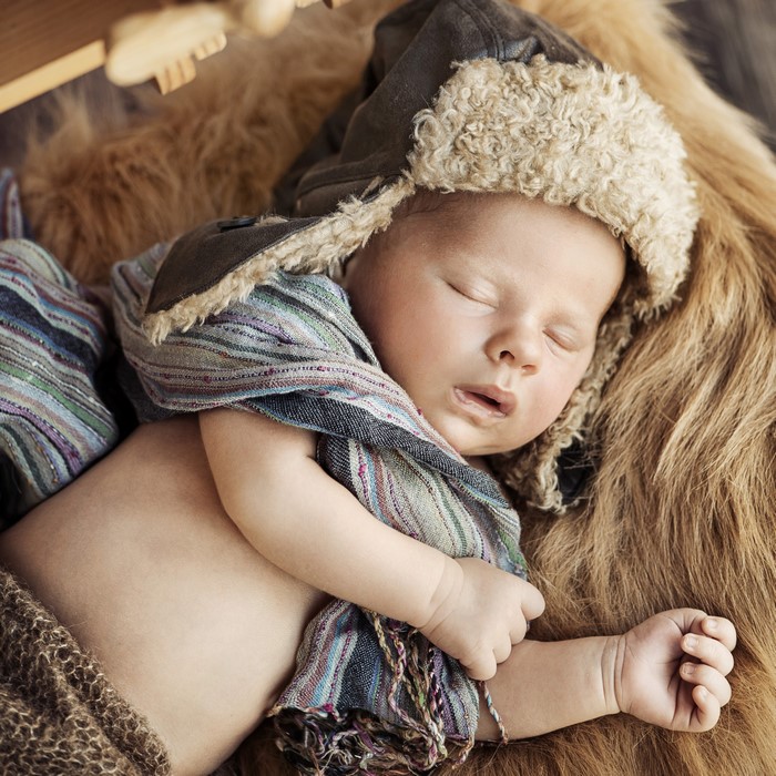 Baby sleeping in winter hat and scarf