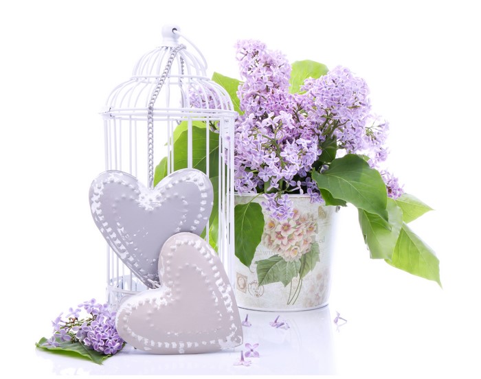 Lilac flowers with decorative hearts and birdcage