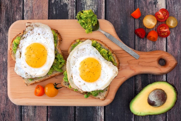 Avocado Toast with Fried Eggs on a Cutting Board