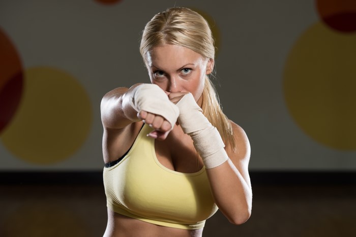 Blonde woman boxing with hand wraps