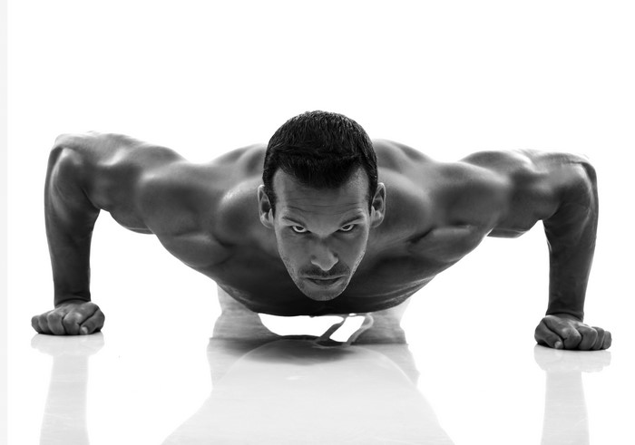 Man doing push-ups on white background