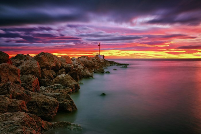Sunset over the coast of Valencia, Spain with lighthouse