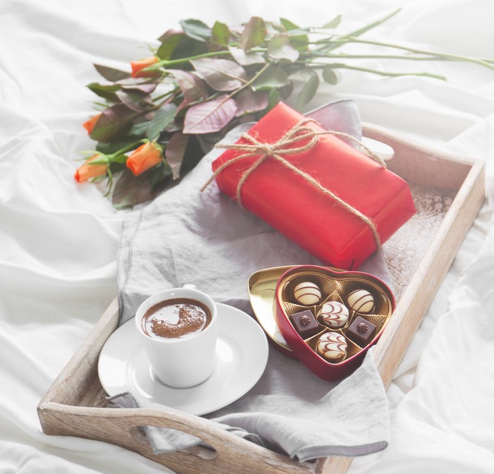Valentine's Day breakfast tray with roses, gift, coffee, and chocolates