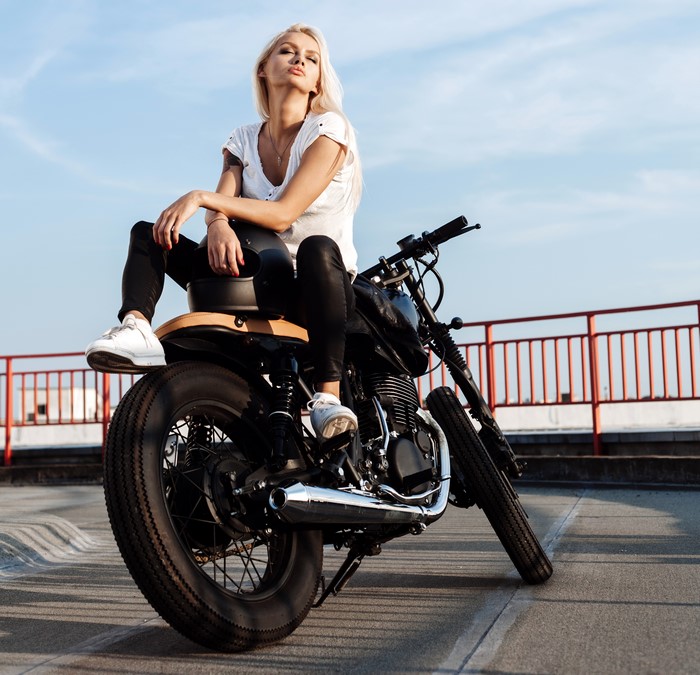 Blonde woman sitting on a motorcycle