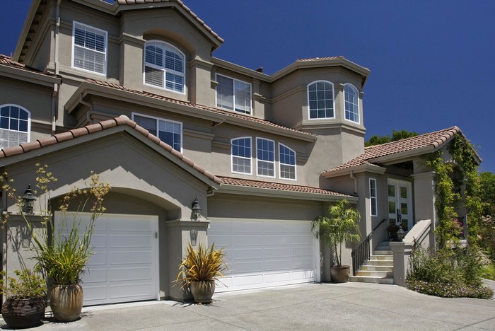 Luxury house with a three-car garage and manicured landscaping