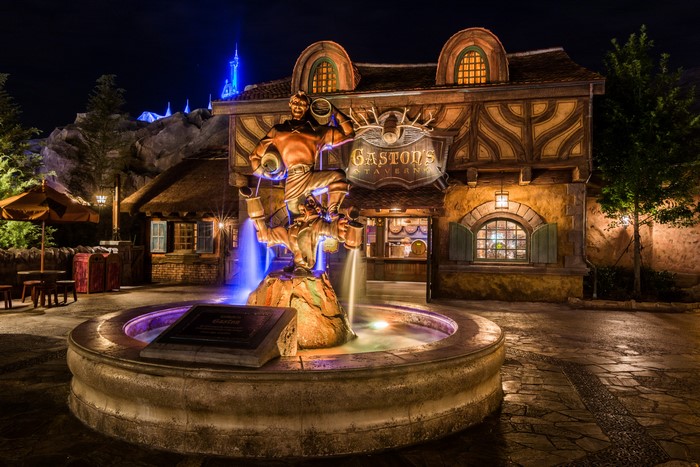 Gaston's Tavern fountain sculpture at night in Disneyland