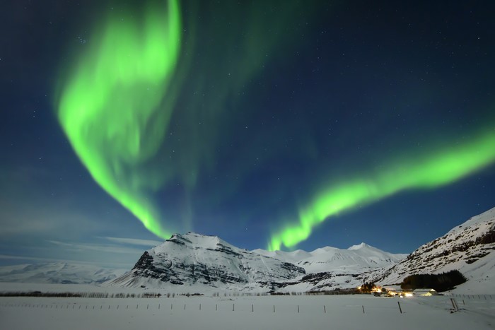 Aurora Borealis over Snow-Covered Mountains in Iceland