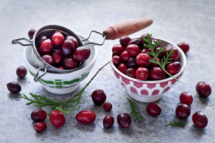 Cranberries in bowls with branches