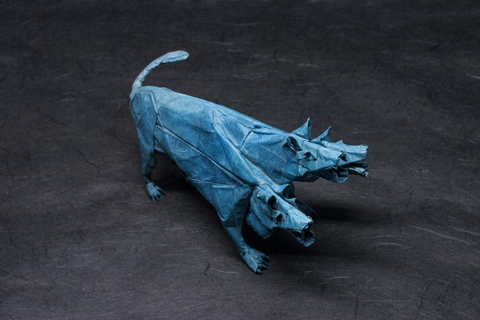Blue origami Cerberus on a dark background