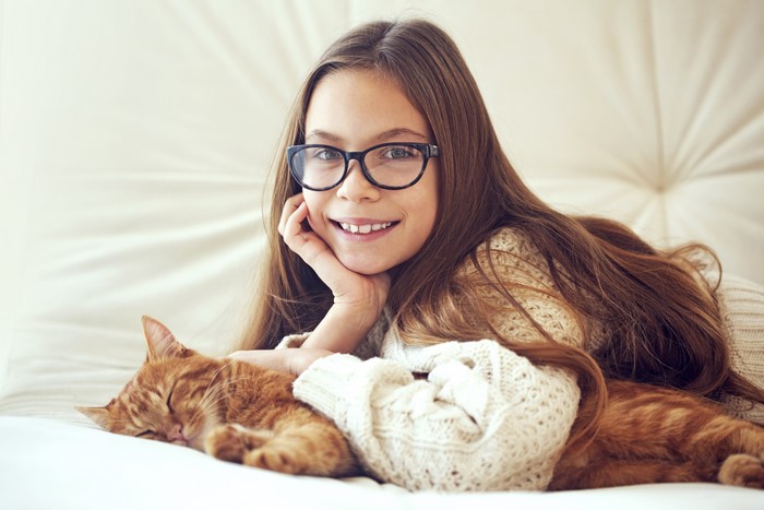 Girl with Glasses and Orange Cat