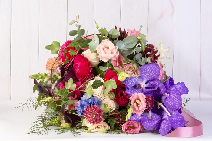 Bouquet with Orchids, Eustoma, and Ranunculus on Wood Planks