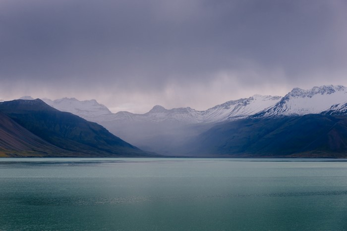 Mountains and lake in Iceland under cloudy sky