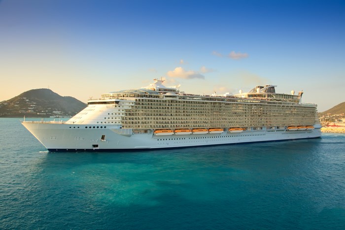 Cruise liner sailing on turquoise sea near islands