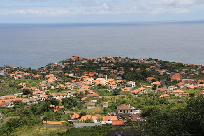 Houses on a hillside overlooking the ocean in Madeira, Portugal