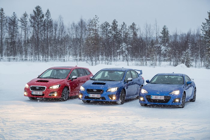 Three Subaru cars in snow