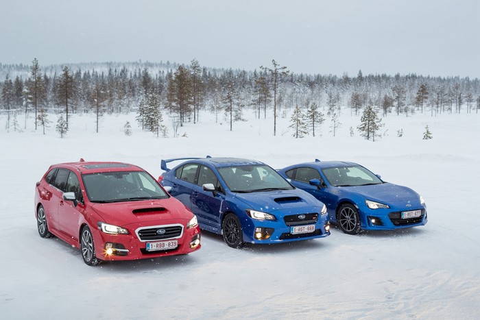 Three Subaru cars in the snow