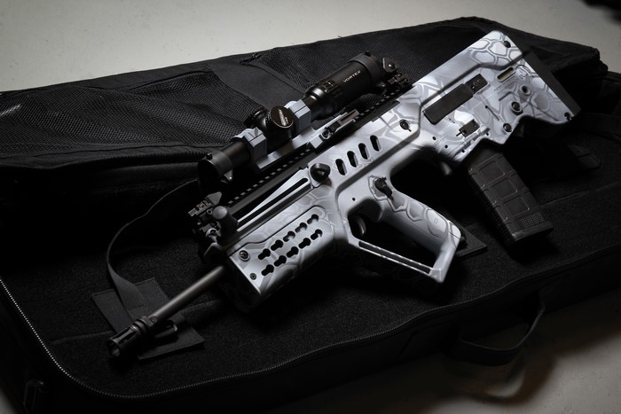 TAR-21 assault rifle with scope on case