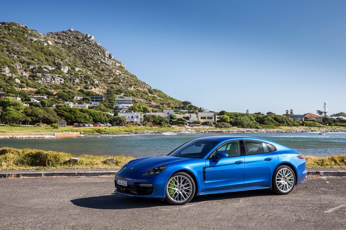 Blue Porsche Panamera 4 E-Hybrid parked by the sea