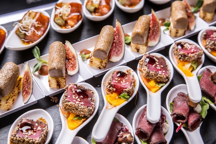 Assortment of gourmet appetizers on a dark surface