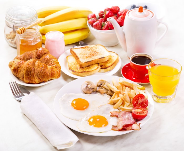 Breakfast with Eggs, Croissants, Toast, and Fruit