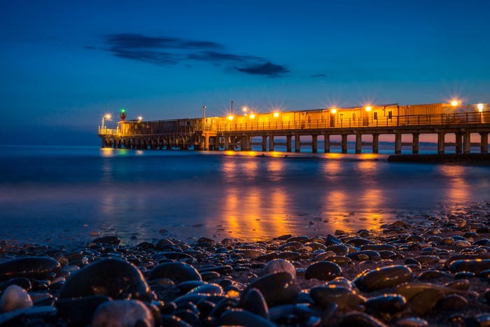 Pier with lights over the sea at night, Sochi, Russia